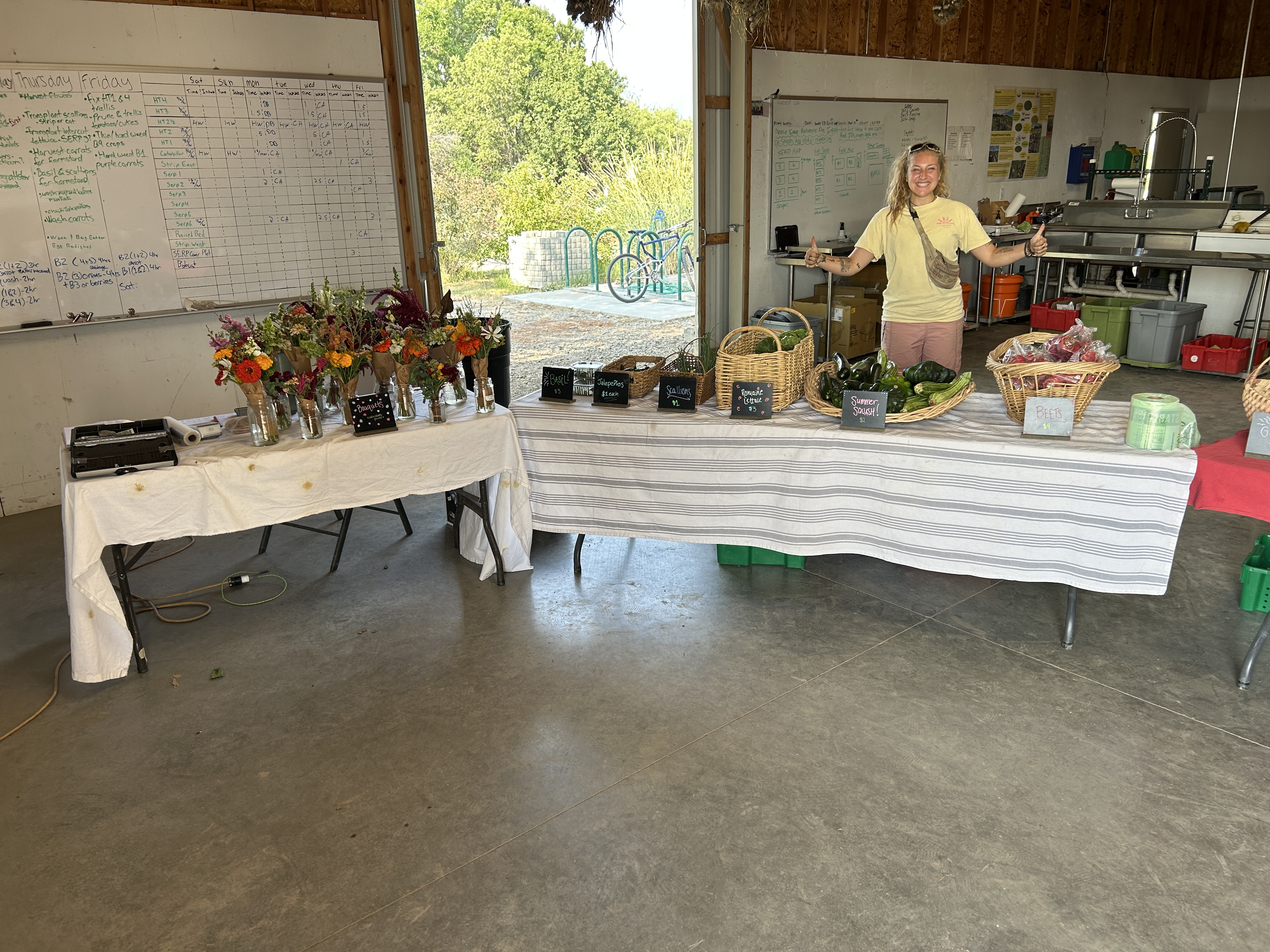 Student displaying veggies at farmstand